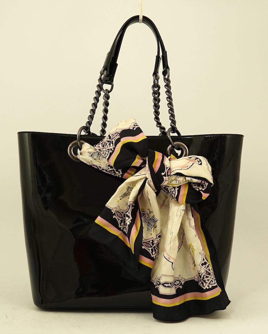 A DKNY black patient leather tote with scarf detail.